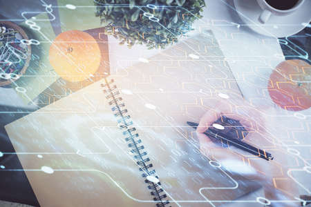 Double exposure of writing hand on background with data solution technology hologram. Ai concept.の写真素材