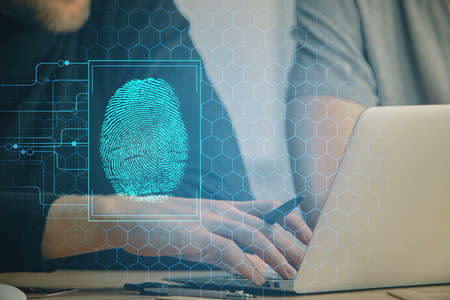Fingerprint hologram with businessman working on computer on background. Security concept. Double...