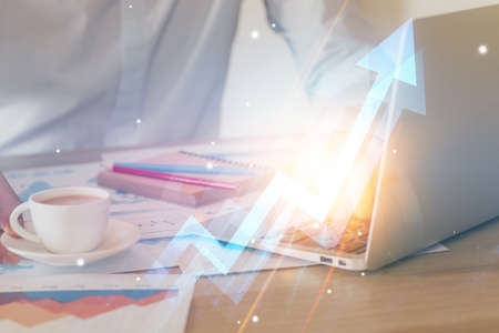 Growing arrows with businessman working on computer on background. Success concept. Double exposure.