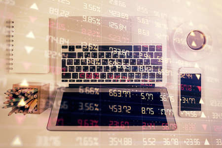 Stock market chart and top view computer on the table background. Multi exposure. Concept of...