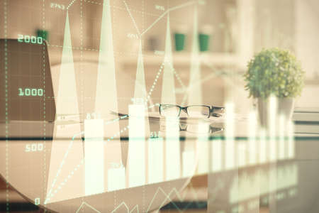 Double exposure of financial graph drawing and office interior background. Concept of stock market.の写真素材