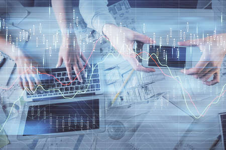 Multi exposure of man and woman working together and forex graph hologram drawing. Financial...