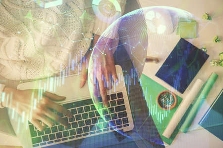 Multi exposure of woman hands working on computer and forex chart hologram drawing. Top View....