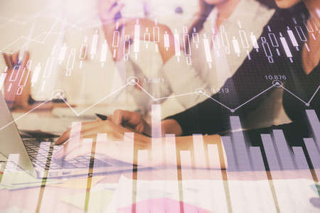 Multi exposure of woman hands typing on computer and financial graph hologram drawing. Stock market...