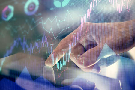 Multi exposure of mans hands holding and using a phone and financial chart drawing. Market analysis...