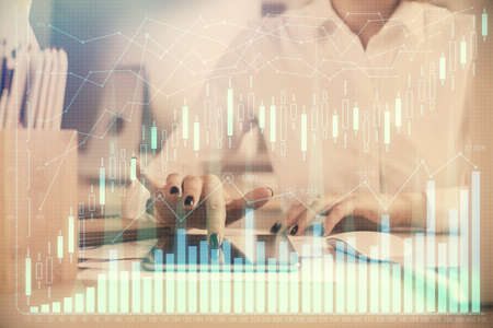 Double exposure of forex chart sketch hologram and woman holding and using a mobile device....