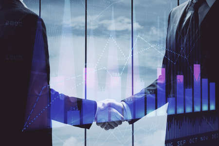 Double exposure of forex graph hologram and handshake of two men. Stock market concept.