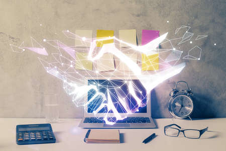 Desktop computer background in office and handshake hologram drawing. Double exposure. Pertnership...