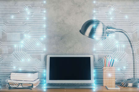 Computer on desktop in office with technology theme hologram. Double exposure. Tech concept.