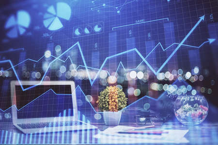 Financial graph colorful drawing and table with computer on background. Double exposure. Concept of...