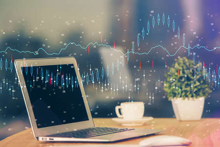 Double exposure of forex chart and work space with computer. Concept of international online...