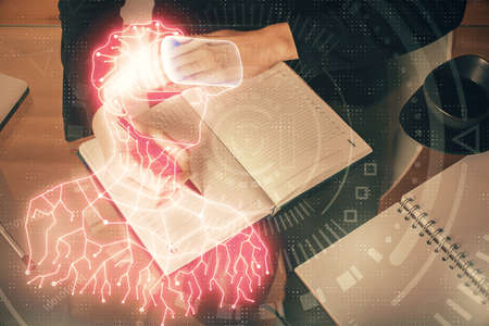 AR hologram over womans hands taking notes background. Concept of augmented reality. Multi exposure