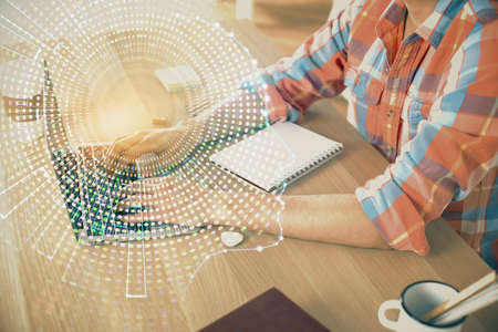 Man typing on keyboard background with brain hologram. Concept of big Data.の写真素材