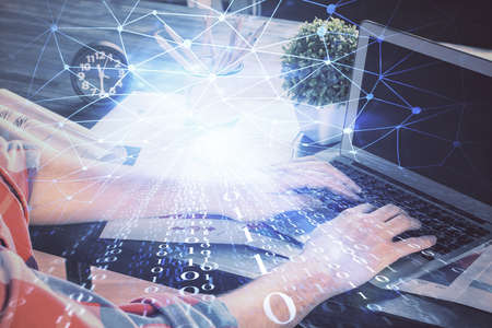 Double exposure of technology hologram with man working on computer background. Concept of big data.