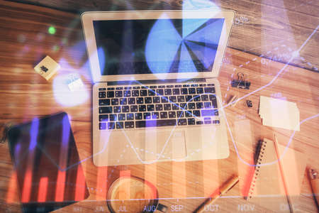 Multi exposure of financial chart drawing over table background with computer. Concept of research...