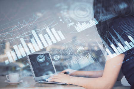 Double exposure of businesswoman hands typing on computer and forex chart hologram drawing. Financial analysis concept.の写真素材