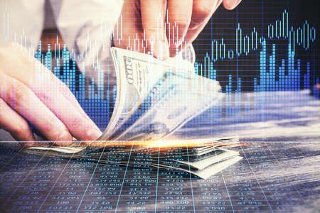 Multi exposure of forex graph drawing hologram and USA dollars bills and man hands. Technical...