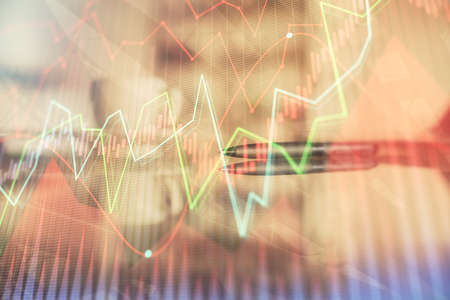 Double exposure of forex chart over coffee cup background in office. Concept of financial analysis...