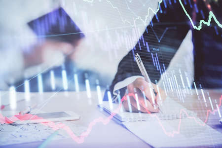 Double exposure of forex chart drawing over people taking notes background. Concept of financial...