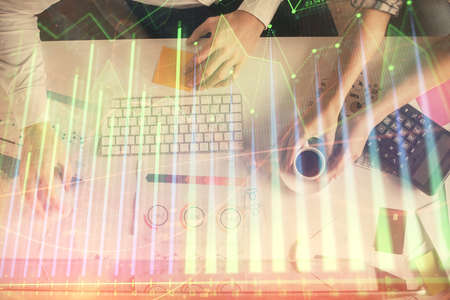 Double exposure of man and woman working together and financial chart hologram drawing. market...