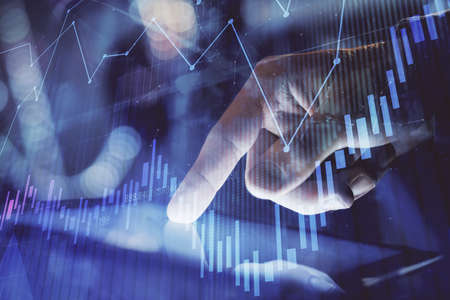 Multi exposure of mans hands holding and using a phone and financial chart drawing. Market analysis...