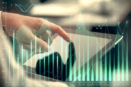 Multi exposure of mans hands holding and using a phone and financial chart drawing. Market analysis...