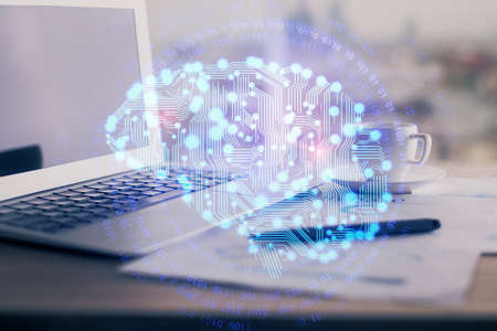 Double exposure of desktop with computer and brain drawing hologram. Artificial intelligence concept.の写真素材
