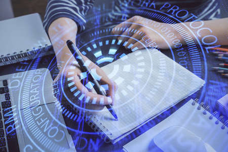 Double exposure of hands making notes with digital coding icons. Computer learning concept.