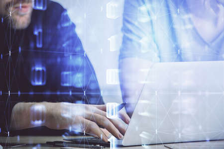 Multi exposure of data internet theme hologram with man working on computer on background. Concept...