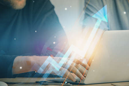 Growing arrows with businessman working on computer on background. Success concept. Double exposure.