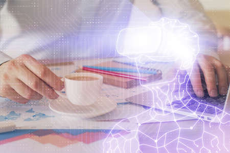 AR hologram with man working on computer on background. Augmented reality concept. Double exposure.