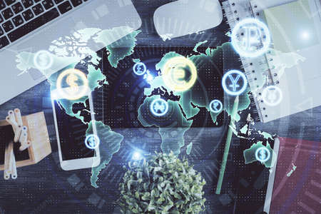 Double exposure of forex chart hologram over desktop with phone. Top view. Mobile trade platform...