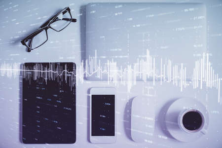 Multi exposure of financial chart hologram over desktop with phone. Top view. Mobile trade platform...