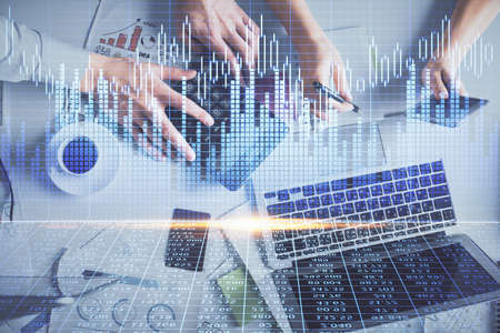 Double exposure of man and woman working together and financial chart hologram drawing. market...