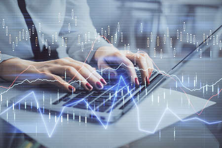 Multi exposure of woman hands typing on computer and financial graph hologram drawing. Stock market...