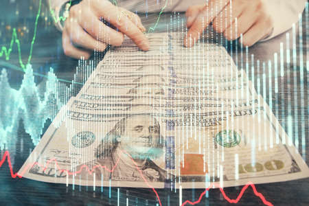 Multi exposure of forex graph drawing hologram and USA dollars bills and man hands. Technical Analysis concept.の写真素材