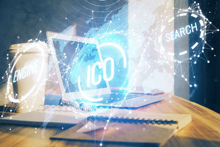 Double exposure of blockchain theme hologram and table with computer background. Concept of bitcoin crypto currency.の写真素材