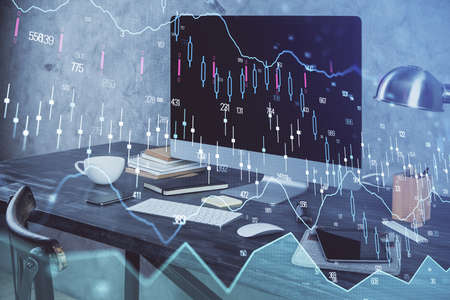 Financial graph colorful drawing and table with computer on background. Double exposure. Concept of international markets.の写真素材