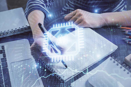 Double exposure of hands making notes with digital coding icons. Computer learning concept.