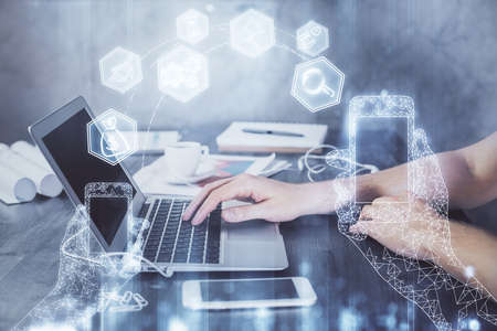 Technology theme hologram with man working on computer on background. High tech concept. Double...