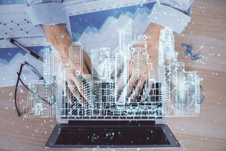 High tech city drawing with businessman working on computer on background. Smartcity concept. Double...