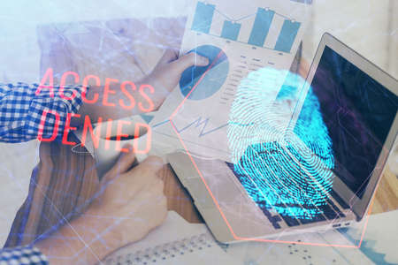 Fingerprint hologram with businessman working on computer on background. Security concept. Double...