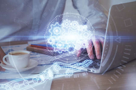 Double exposure of data internet theme hologram with man working on computer on background. Concept...