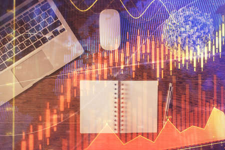 Stock market graph and top view computer on the table background. Double exposure. Concept of...