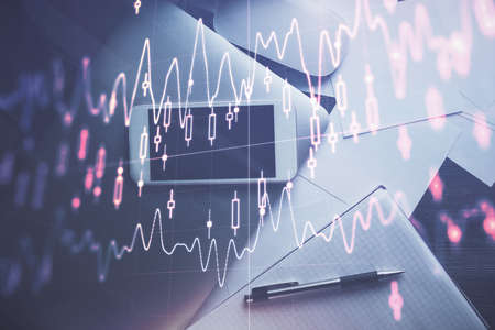 Multi exposure of forex graph hologram over desktop with phone. Top view. Mobile trade platform...