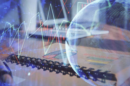 Double exposure of financial graph drawings and desk with open notebook background. Concept of forex...