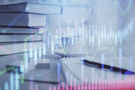 Double exposure of financial chart drawing and desktop with coffee and items on table background. Concept of forex market tradingの写真素材