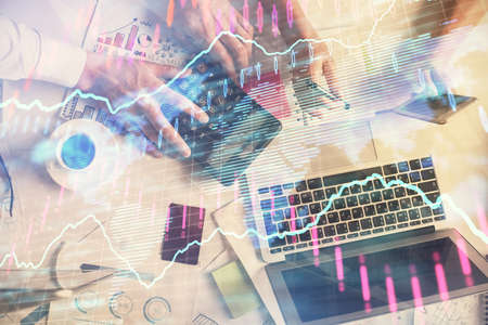 Double exposure of man and woman working together and financial chart hologram drawing. market...