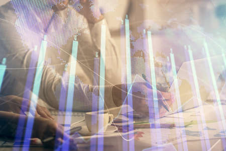 Multi exposure of man and woman working together and financial chart hologram. Business concept....