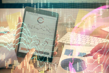 Multi exposure of mans hands holding and using a phone and financial chart drawing. Market analysis...